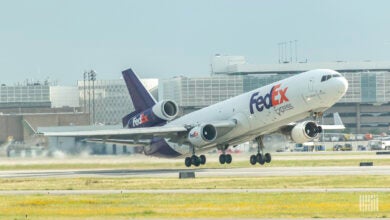 A purple-tailed FedEx plane takes off.