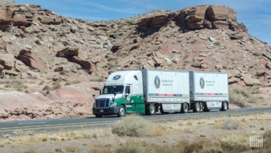 An Old Dominion tractor with two LTL trailers on a highway in the desert