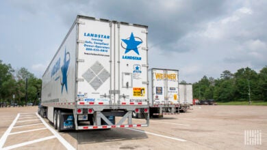 a Landstar tractor-trailer parked next to a Werner rig