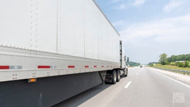 A white tractor-trailer on the highway