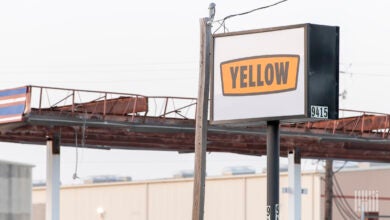 a tattered facade near a Yellow marquee