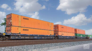 Orange Schneider intermodal containers on a well car