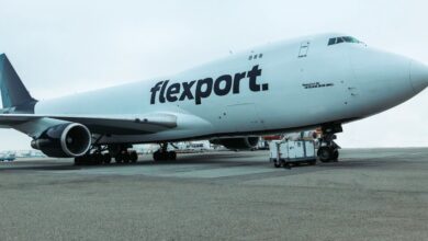 Photo of a white 747 jet with a blue tail and Flexport logo.