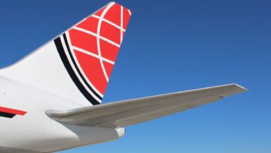 Close up of the red-tail of a large aircraft.