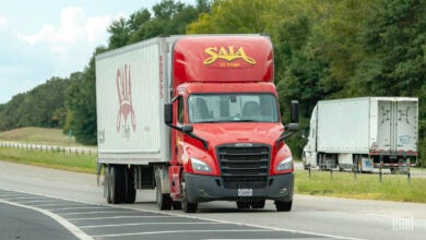 A red Saia tractor pulling a white Saia '53 dry van