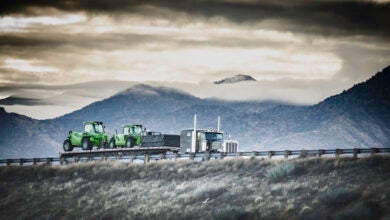 Truck hauling tractors