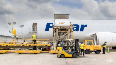 A white Polar air cargo jet gets loaded with a container through a side door.