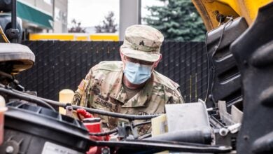 Army reservist fixing a truck