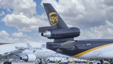 Close up of a brown-tailed UPS freighter with a rear engine on the ground.