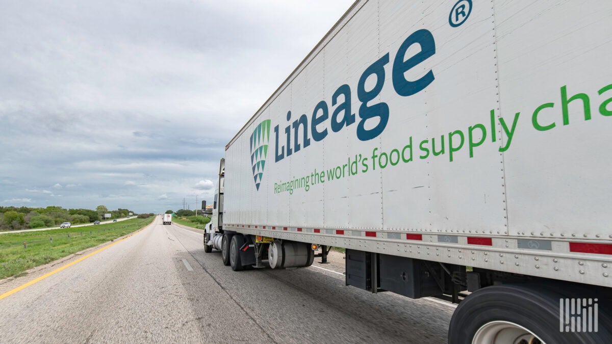 A Lineage Logistics trailer being pulled on a highway