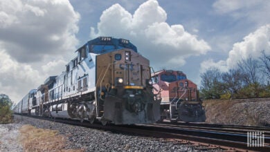 Two locomotives in a rail yard.