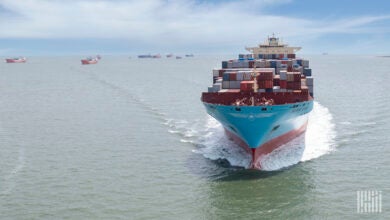 A Maersk container ship cruises outside Galveston, Texas, with other container ships seen in the background.