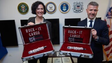 Foam-protected cases for carrying fragile electronic equipment being displayed open by a woman and a man on behalf of Rock-it Cargo.