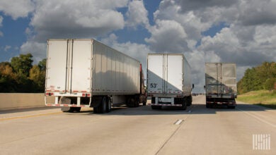 three tractor trailers on a highway