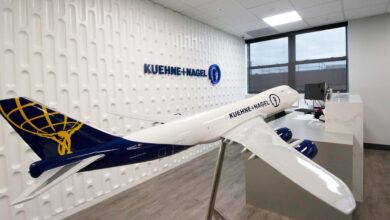 A model plane with Kuehne+Nagel brand on it resting in an office