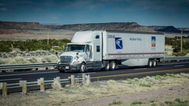 US Postal Service long-haul truck on the highway.