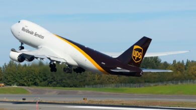 A brown-tail UPS jumbo jet takes off on a clear day.