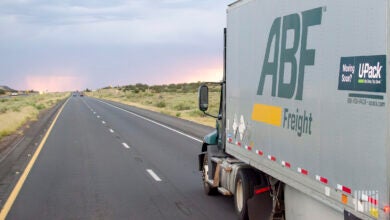 Sideview of an ABF tractor and LTL trailer on a highway