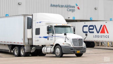 Truck trailers parked at an American Airlines cargo terminal.