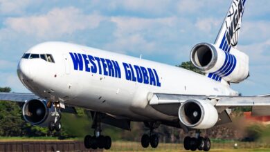 A tri-engine jet with Western Global logo touches down at an airfield.