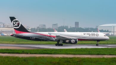 Black-tailed SF Airlines freighter taxis at an airport.