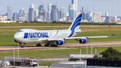 A National Airlines jumbo jet ready to takeoff with the Austin, Texas, skyline in the background.