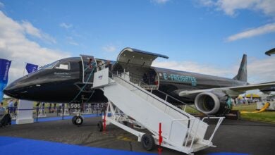 An a charcoal colored Embraer E-Freighter on display at an airshow.