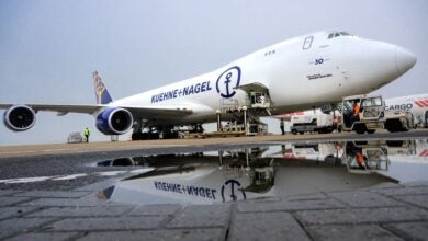 A Kuehne+Nagel jumbo jet freighter is loaded with cargo.