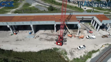 Image shows aerial view of railroad bridge under construction.