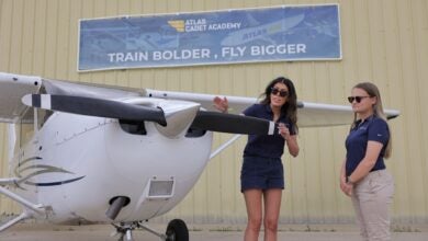 A flight instructor and student talk in front of a small Cessna training plane at the Atlas Air flight academy.