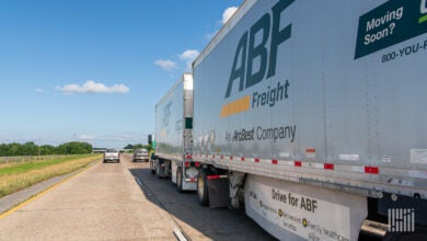 A tractor pulling two ABF Freight trailers on a highway