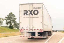 a rear view of an RXO trailer on a highway