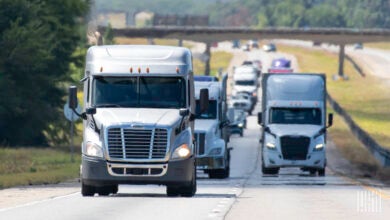 Front view of multiple tractors on a highway