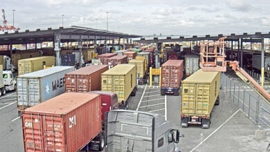 Images shows container trucks, port gates, cloudy sky