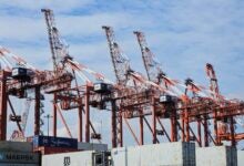 Image shows container cranes and stacks of containers.