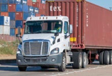 trucks with containers leaving a port