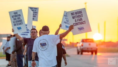 Images shows striking union members holding signs.