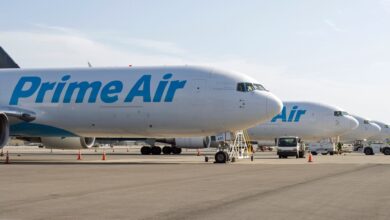 Prime Air freighters with light blue lettering lined up on the tarmac side by side.