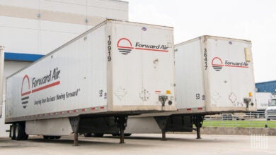 Two Forward Air trailers at an airport facility