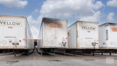 Faded Yellow trailers with exhaust stains parked at a terminal