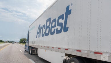 A sideview of an ArcBest trailer on a highway