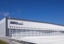 A white building with MRO Japan logo seen on a bright day.