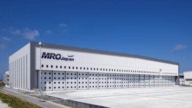 A white building with MRO Japan logo seen on a bright day.