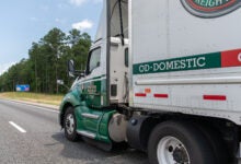 An Old Dominion tractor pulling an OD trailer on a highway