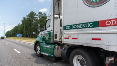 An Old Dominion tractor pulling an OD trailer on a highway