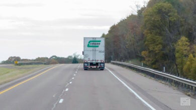 A rearview of a Cowan trailer being pulled on a highway