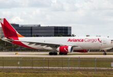 An Avianca Cargo jet with red color scheme moves down the runway.