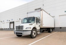 A white last-mile truck with a liftgate at a Prologis warehouse