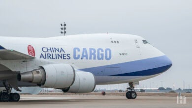 Front half of white/light blue China Airlines Cargo 747 jet on the ground.