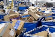 Piles of packages in bins at a U.S. Postal Service facility.